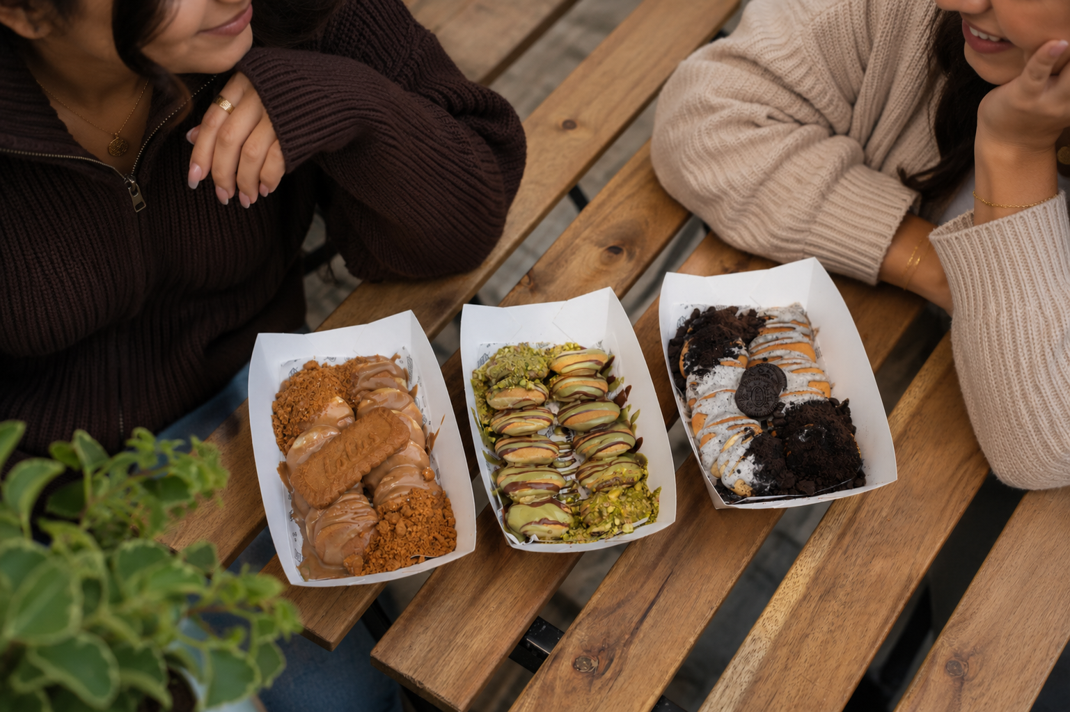 Chocolate and pistachio pancakes and waffles shared around a table